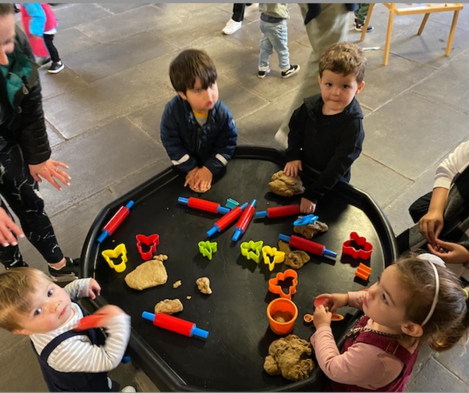 A group of five children playing with play dough